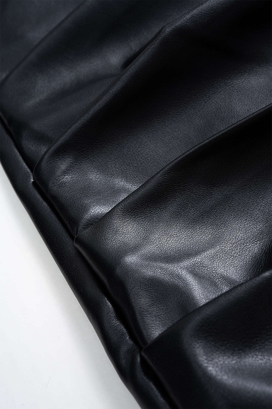 Asymmetric mini skirt in faux leather with ruffles 