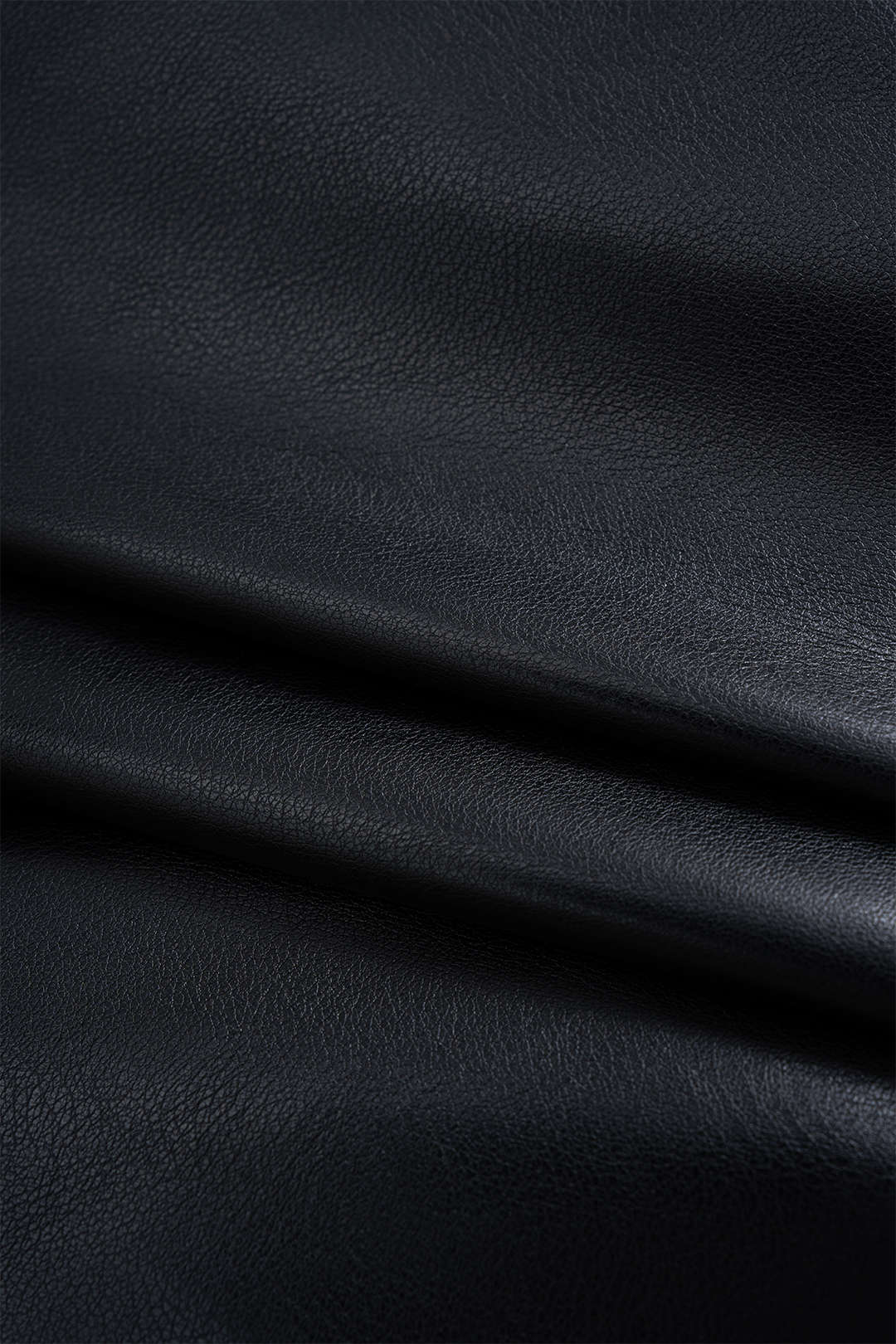 Asymmetric mini skirt in faux leather with ruffles 